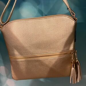 Golden Crossbody Bag with double outside zip pockets.